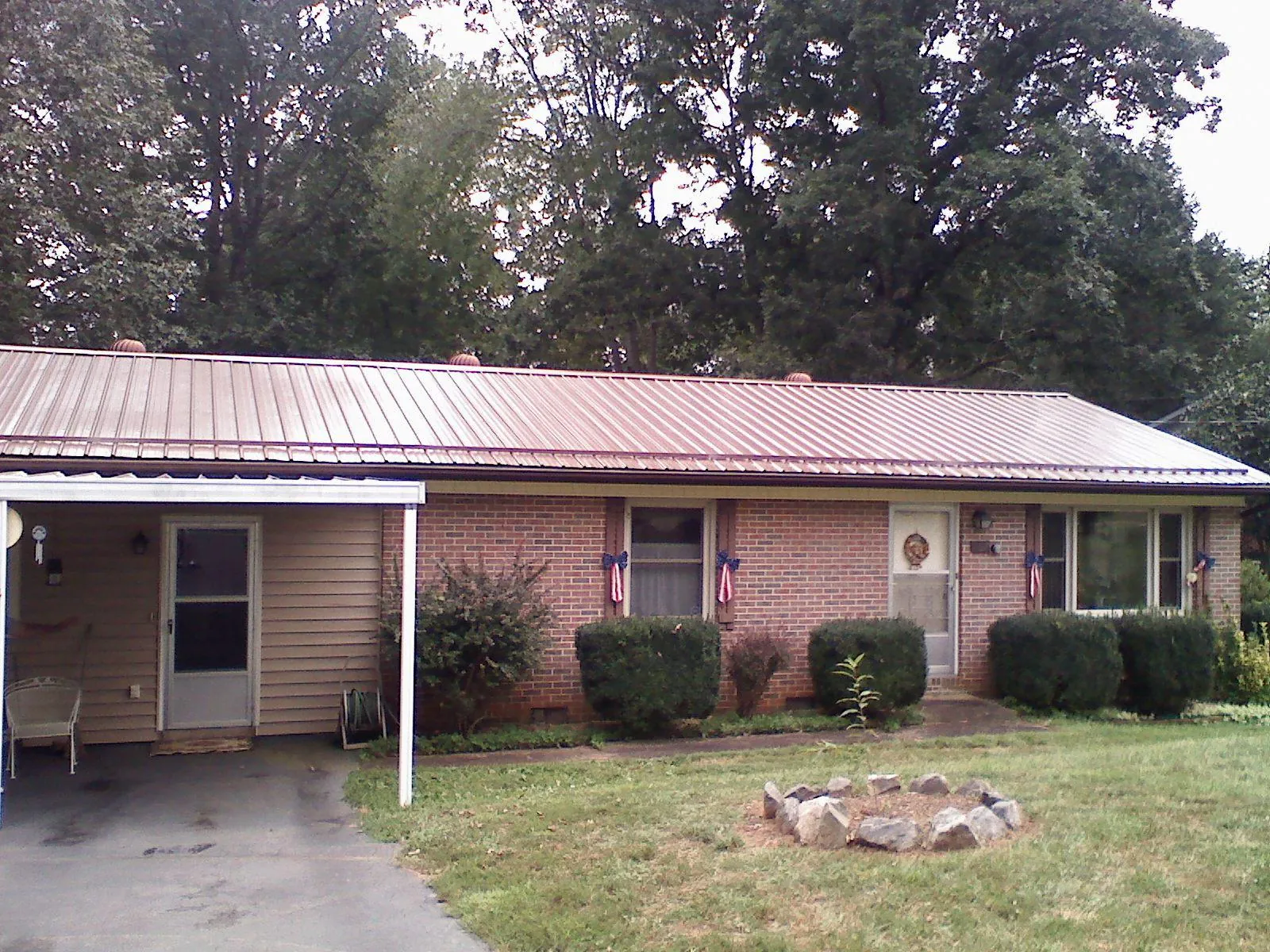 Bronze metal roof and carport on a brick ranch home — Roof Repair work by our crew in Fernwood